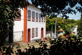 Azorean style townhouse framed by trees